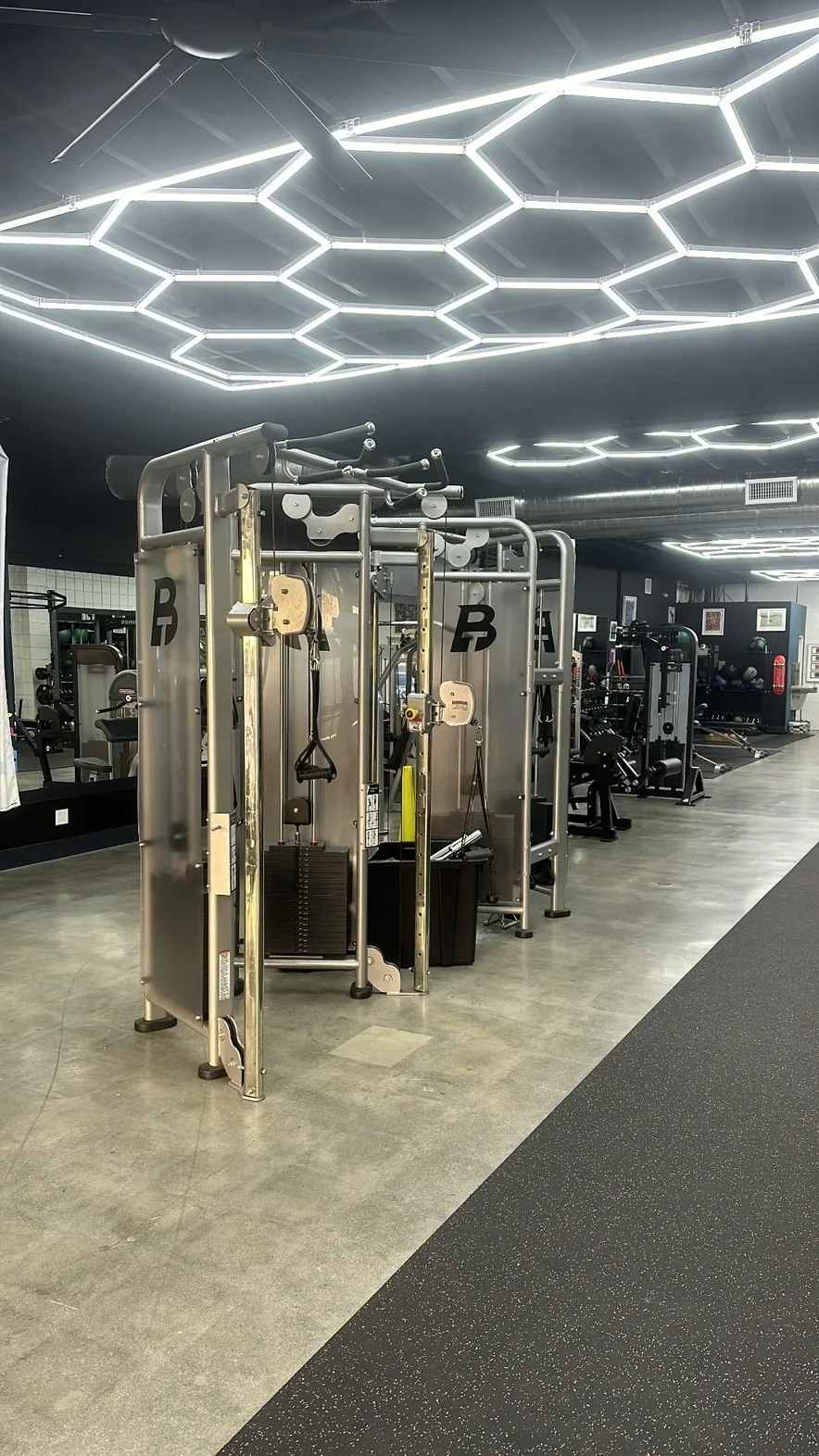 BT-branded functional cable trainers beneath honeycomb LED ceiling lights